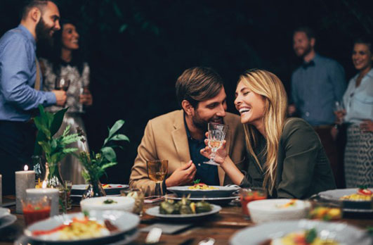 The Line photo of a couple socializing and laughing over dinner