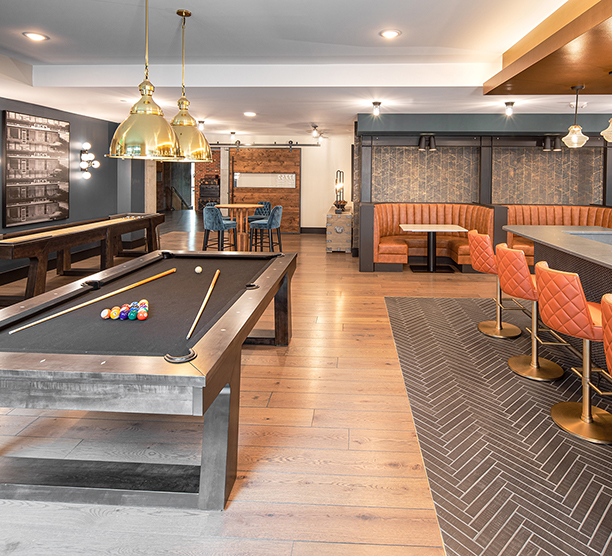 The Line clubroom gaming area with a pool table and booth seating