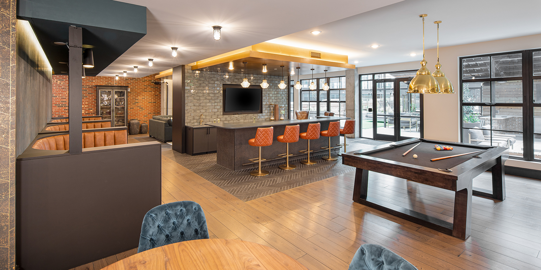 The Line clubroom kitchen area featuring a pool table, booth seating, and seating along the bar