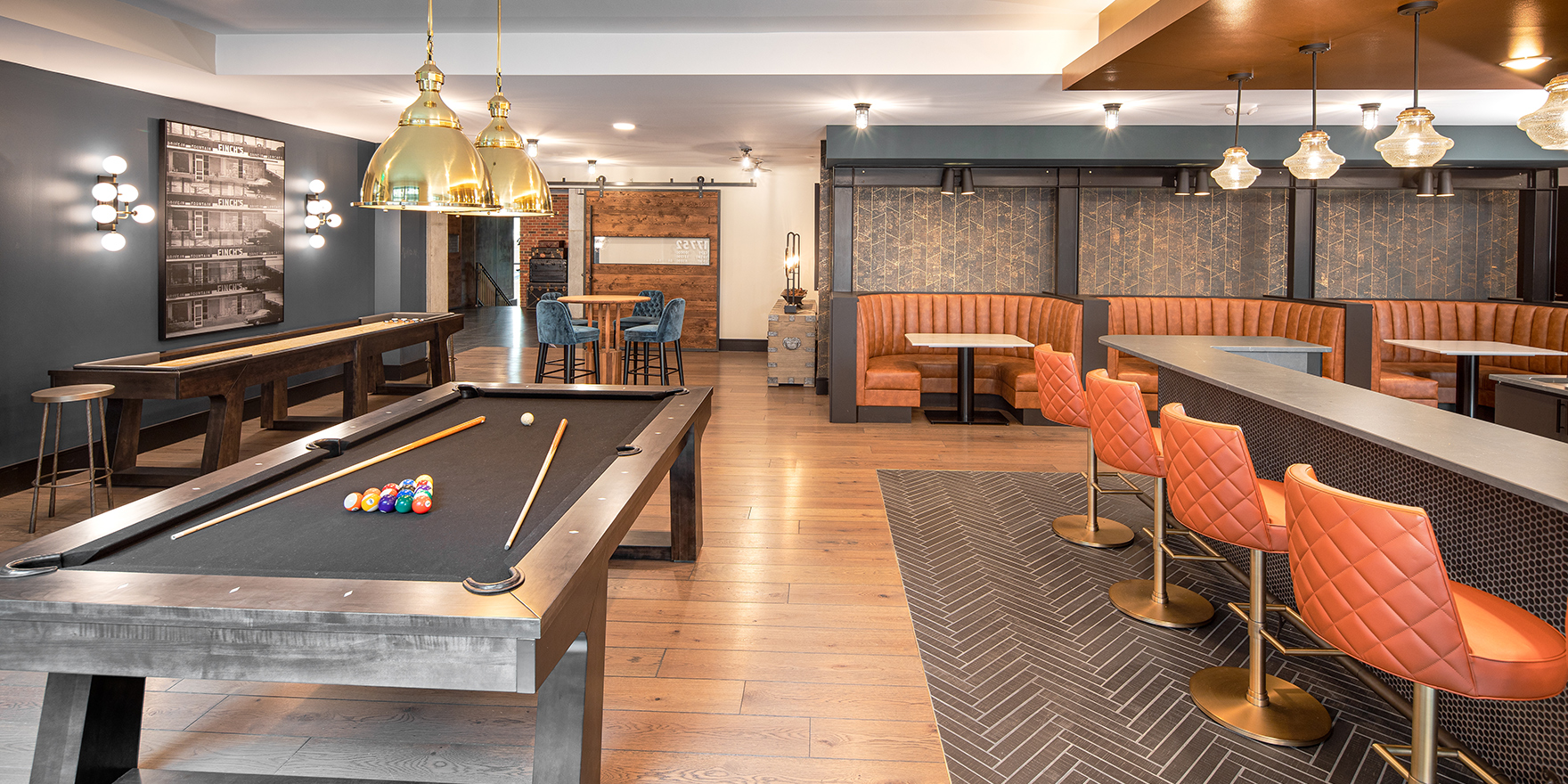 The Line clubroom gaming area featuring a pool table, booth seating, and seating along the bar