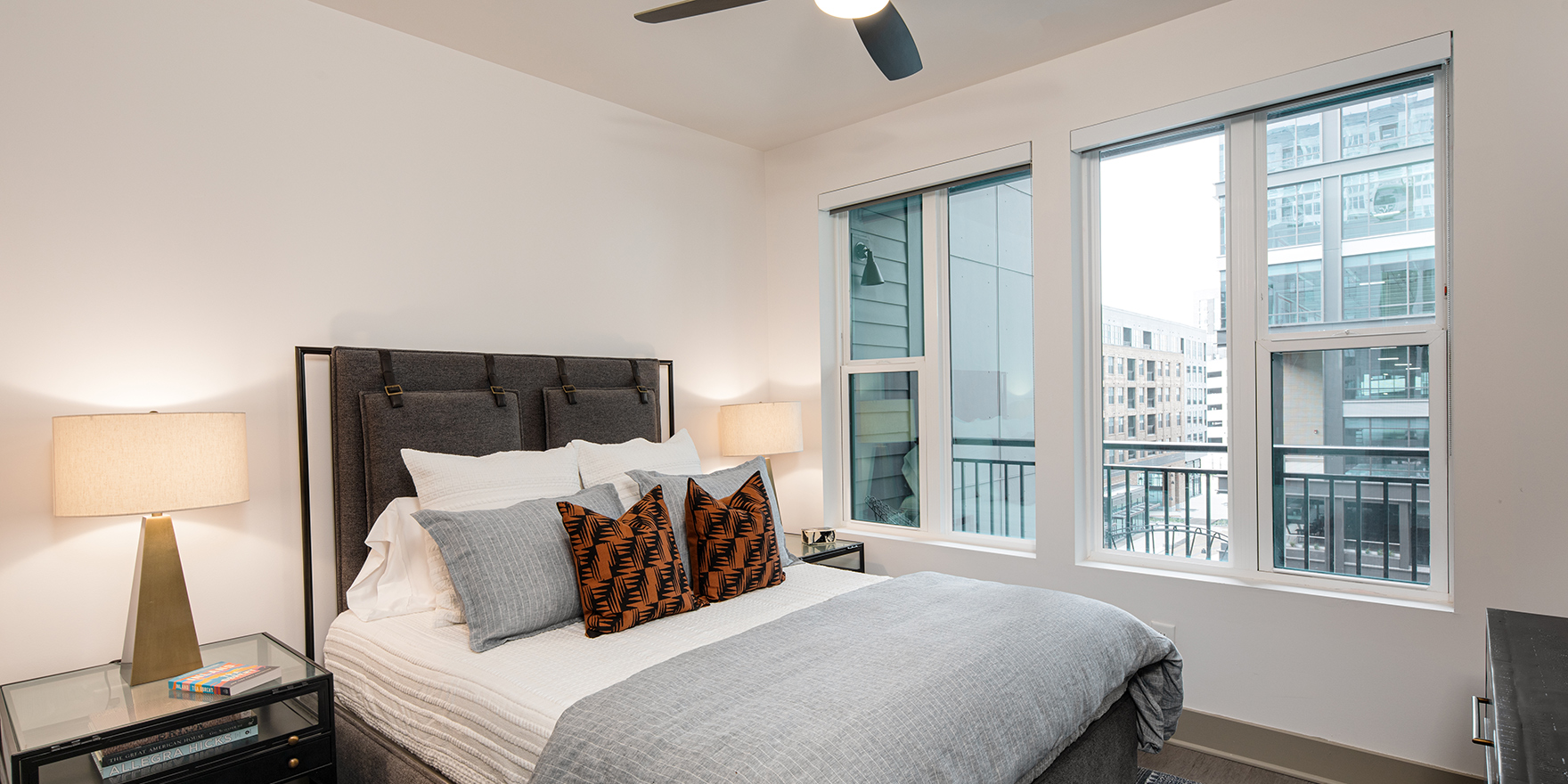 The Line one bedroom apartment bedroom with window view of surrounding city-scape