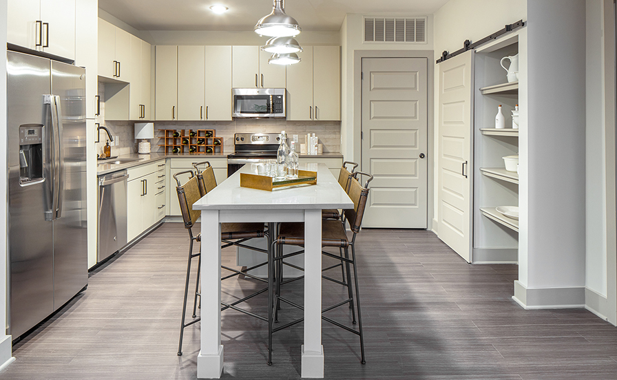The Line two bedroom apartment kitchen with island and stainless steel appliances